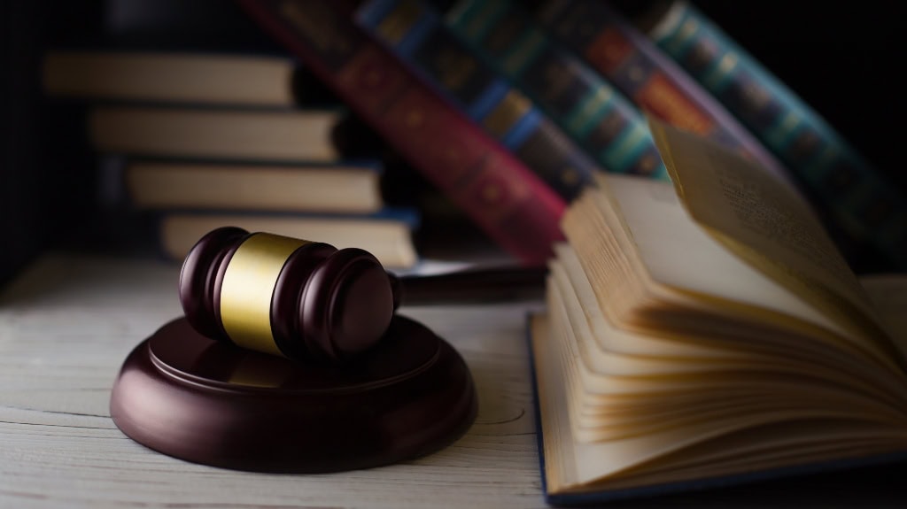 Which Criminal Offenses Are Eligible for Expungement in Indiana? Wooden hammer on the books background