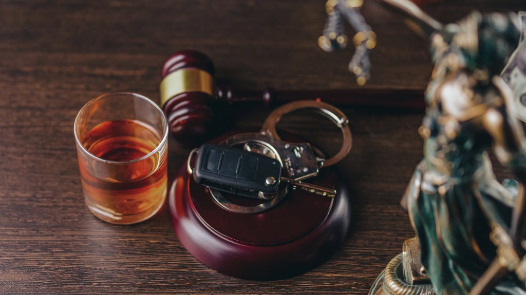 Can a DUI Be Expunged in Indiana? - Kaushal Law LLC Whiskey with car keys and handcuffs